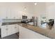 Bright kitchen with white cabinets, granite countertops, stainless steel appliances, and island at 31949 Amberlea Rd, Dade City, FL 33523