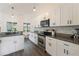 Bright kitchen with granite countertops, stainless steel appliances, and modern white cabinetry at 31949 Amberlea Rd, Dade City, FL 33523