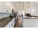 Well-lit kitchen with stainless steel appliances, stone countertops, and white cabinetry at 31949 Amberlea Rd, Dade City, FL 33523
