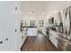 Modern kitchen features white cabinets, stone countertops, and stainless steel appliances at 31949 Amberlea Rd, Dade City, FL 33523