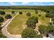 Vast land with green pastures, mature trees, and a gravel road bordering the property at 31949 Amberlea Rd, Dade City, FL 33523