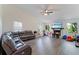 Comfortable living room features a fireplace, large windows, and neutral décor at 31949 Amberlea Rd, Dade City, FL 33523