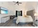 Comfortable main bedroom features high ceilings, TV, balcony access, seating area, and tufted headboard at 31949 Amberlea Rd, Dade City, FL 33523