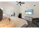 Spacious main bedroom featuring a vaulted ceiling, TV, and comfortable seating area at 31949 Amberlea Rd, Dade City, FL 33523