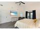 Comfortable main bedroom features high ceilings, TV, balcony access, seating area, and gray plank flooring at 31949 Amberlea Rd, Dade City, FL 33523