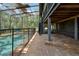 View of the screened pool area and backyard, blending indoor and outdoor living for a relaxing experience at 31949 Amberlea Rd, Dade City, FL 33523