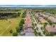 An aerial view displaying a property surrounded by other homes close to a green space at 32624 Summerglade Dr, Wesley Chapel, FL 33545
