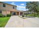 Backyard with large patio, seating, lush green grass, privacy fence, and an exterior view of the home at 32624 Summerglade Dr, Wesley Chapel, FL 33545