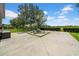 Backyard with large patio, seating, lush green grass, privacy fence, and a blue sky with clouds at 32624 Summerglade Dr, Wesley Chapel, FL 33545