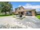 Backyard with patio, seating, lush green grass, privacy fence, and an exterior view of the home at 32624 Summerglade Dr, Wesley Chapel, FL 33545