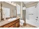Well-lit bathroom with granite counters and tub shower with curtain at 32624 Summerglade Dr, Wesley Chapel, FL 33545