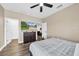 Bedroom with TV, wood floors, two closets, and a doorway leading to another room at 32624 Summerglade Dr, Wesley Chapel, FL 33545