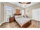 Cozy bedroom with a ceiling fan, wood-look flooring, and natural light at 32624 Summerglade Dr, Wesley Chapel, FL 33545