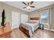 Bedroom features wood-look flooring, ceiling fan, and closet at 32624 Summerglade Dr, Wesley Chapel, FL 33545