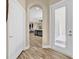 Hallway view of kitchen, living area, and door to the outside at 32624 Summerglade Dr, Wesley Chapel, FL 33545