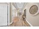 Hallway showcasing wood-look tile flooring, tray ceilings, decorative wall accents, and inviting natural light at 32624 Summerglade Dr, Wesley Chapel, FL 33545