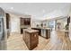 Spacious open-concept kitchen with a center island, stainless steel appliances, and wood-style flooring at 32624 Summerglade Dr, Wesley Chapel, FL 33545