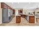 Bright kitchen showcases wooden cabinets, an island, granite counters, and stainless steel appliances at 32624 Summerglade Dr, Wesley Chapel, FL 33545