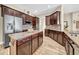 A gourmet kitchen boasts wooden cabinetry, a center island, and stainless steel appliances at 32624 Summerglade Dr, Wesley Chapel, FL 33545