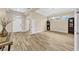 Inviting living room showcasing wood-look tile flooring, high ceilings, and abundant natural light at 32624 Summerglade Dr, Wesley Chapel, FL 33545