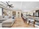 Living room with a ceiling fan and a view of the kitchen with island seating at 32624 Summerglade Dr, Wesley Chapel, FL 33545
