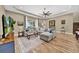 Open living room featuring a tray ceiling, ceiling fan, and wood-look flooring at 32624 Summerglade Dr, Wesley Chapel, FL 33545