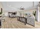 Open concept living room and kitchen with wood-look flooring and modern decor at 32624 Summerglade Dr, Wesley Chapel, FL 33545