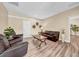 Comfortable living room with hardwood floors, a sofa and arm chairs at 32624 Summerglade Dr, Wesley Chapel, FL 33545