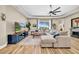 Bright living room with wood-look floors and a large comfy sectional sofa at 32624 Summerglade Dr, Wesley Chapel, FL 33545