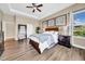 A relaxing primary bedroom is filled with natural light and features wood-style flooring at 32624 Summerglade Dr, Wesley Chapel, FL 33545
