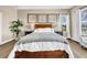 Comfortable primary bedroom featuring stylish decor, natural light, and wood-style flooring at 32624 Summerglade Dr, Wesley Chapel, FL 33545