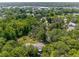 Aerial view of lush property featuring mature trees, and proximity to a neighborhood and road at 3373 Olson Rd, Spring Hill, FL 34607