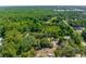 Aerial showcasing wooded lot and verdant surroundings with residential structure and boat storage on land at 3373 Olson Rd, Spring Hill, FL 34607