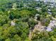 Aerial view of the property showing wooded areas, lush vegetation, and neighborhood location at 3373 Olson Rd, Spring Hill, FL 34607