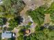 Aerial view showcasing the property layout, sheds, and lush surroundings at 3373 Olson Rd, Spring Hill, FL 34607