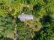 Aerial view of home nestled among lush trees and spacious lot at 3373 Olson Rd, Spring Hill, FL 34607
