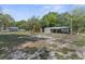 Spacious, tree-filled backyard with storage shed, arbor and chain link fence at 3373 Olson Rd, Spring Hill, FL 34607