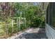 Backyard featuring a white arbor, concrete patio, and lush greenery and trees at 3373 Olson Rd, Spring Hill, FL 34607