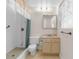 Traditional bathroom featuring a walk-in shower, single vanity, and window that offers natural light at 3373 Olson Rd, Spring Hill, FL 34607