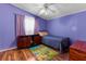 Cozy bedroom with blue walls and wood-look flooring at 3373 Olson Rd, Spring Hill, FL 34607