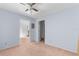 This empty bedroom offers two closets, ceiling fan, carpet and easy access to the connected rooms at 3373 Olson Rd, Spring Hill, FL 34607