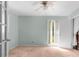 Well-lit room featuring a ceiling fan, light-green walls, and a window with view of green yard at 3373 Olson Rd, Spring Hill, FL 34607