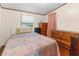 Bright secondary bedroom with natural light and wood dresser at 3373 Olson Rd, Spring Hill, FL 34607