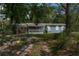 Charming single-story home featuring a screened-in porch and mature landscaping at 3373 Olson Rd, Spring Hill, FL 34607
