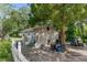 Exterior shot of detached garage with side storage and mature tree at 3373 Olson Rd, Spring Hill, FL 34607