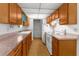 Bright kitchen with light wood cabinets, laminate counters, and white appliances at 3373 Olson Rd, Spring Hill, FL 34607