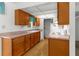 Traditional-style kitchen features wood cabinets, light countertops, and an electric cooktop at 3373 Olson Rd, Spring Hill, FL 34607