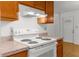 Electric stovetop appliance with wood cabinets and countertop microwave hood at 3373 Olson Rd, Spring Hill, FL 34607