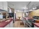 Bright kitchen features white cabinets, pink countertops, and opens to dining area at 3373 Olson Rd, Spring Hill, FL 34607