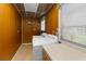 Laundry area with washer, dryer, wood paneled walls, and window for natural light at 3373 Olson Rd, Spring Hill, FL 34607